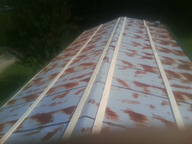 Rusted metal roof panels with new wood purlins before replacement — Storm Damage Roof Repair in Rappahannock Academy by Roofing Brothers