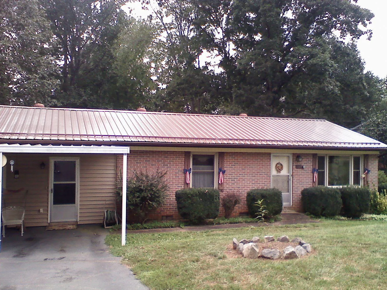 Bronze metal roof and carport on a brick ranch home — Roof Repair work by our crew in Rappahannock Academy
